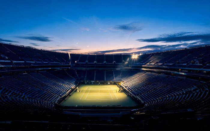 A major tennis stadium at night during a championship